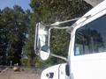 Close-up of a 2008 Peterbilt PB340 truck showing the side mirror and reflective chrome detailing on the driver's side