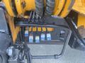 A close-up view of the hydraulic control system on a 2017 Ford F-550 featuring multiple colored levers for various functions
