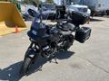 A 2021 Harley-Davidson RA1250 S motorcycle in black with two side panniers and a windshield parked at a construction site