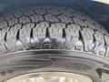 Close-up of a rugged tire tread on a 2014 Chevrolet Express showcasing deep grooves and patterns for improved traction