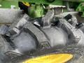 Close-up of a large, rugged tire from a 2003 John Deere 790 tractor showing deep treads and a sturdy rubber composition