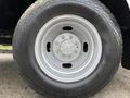 Close-up of a silver wheel with a circular hub and tire tread on a 2013 Ford F-350 SD