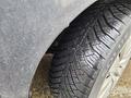 Close-up of a tire on a 2016 Chrysler 200 showing detailed treads and water droplets on the surface