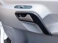 Interior door handle of a 2016 Mercedes-Benz Sprinter with a sleek design and a combination of gray and black colors