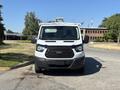 A white 2016 Ford Transit van with a flat front and black grille parked on a road