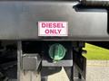 A close-up view of a label reading DIESEL ONLY next to a green diesel fuel cap on a 2021 Ford F-550