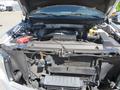 The image shows the open hood of a 2014 Ford F-150 with visible engine components including the air intake and various hoses and wires