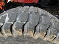 Close-up of a worn tire from a 2011 Kubota M8540D showing distinct tread patterns and signs of use