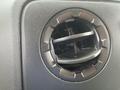 Air vent detail from the dashboard of a 2009 Ford Econoline with adjustable slats for airflow control