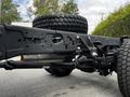 A 2024 Ford F-550 chassis showing the underside with visible suspension components and large tires