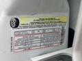 A label on a 2005 Ford F-350 SD providing tire and load information including seating capacity and original tire size details
