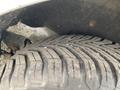 A close-up view of a 2017 Ford Transit Connect tire showcasing its tread pattern with visible wear and some dirt on the surface