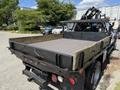 A 2012 Ford F-450 SD with a flatbed featuring wooden side rails and a mounted crane on the back