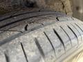Close-up of the tire of a 2005 Chrysler PT Cruiser showing tread pattern and some dirt on the surface