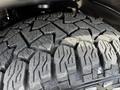 Close-up of the tread on a large tire equipped on a 2019 RAM 1500 showcasing deep grooves and rugged design for traction and durability