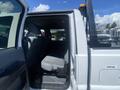 Interior view of a 2016 Ford F-350 SD showing the back seat area with gray upholstery and a clear space for passengers