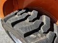 Close-up of a rugged tire from a 2017 Gehl R105 showcasing deep tread patterns designed for optimal traction on various surfaces