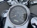 A close-up of a Harley-Davidson speedometer displaying various speed readings in kilometers per hour with a black background and chrome detailing