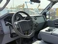 Interior of a 2011 Ford F-350 SD showing the steering wheel dashboard and center console with storage compartments