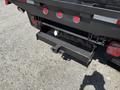 A black tow hitch attached to the rear of a 2012 Ford F-450 SD with visible red taillights and a license plate holder