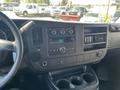 Interior dashboard of a 2013 Chevrolet Express showing the audio system air vents and cup holders