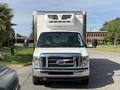 A white 2019 Ford Econoline with a large box truck rear and prominent front grille parked on a street