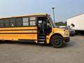 A yellow 2007 Freightliner B2 school bus with multiple windows and an open front door