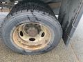 Close-up of a worn tire on a 2008 Dodge Ram 5500 showing visible tread wear and rust on the wheel rim