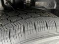 A close-up of a tire on a 2022 Ford Transit showing detailed tread patterns and some dirt on the surface