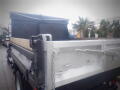 A 2008 Ford F-550 truck with a flatbed and a metal dump body designed for hauling and transporting materials