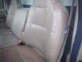 Interior view of a 2008 Ford F-550 with light tan leather seats showing the middle and driver side seat without any occupants