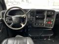 Interior view of a 2006 GMC C5000 showing the steering wheel dashboard controls and audio system with various gauges and switches