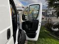 A 2019 RAM Promaster with the driver's side door open showing the interior handle and door panel details