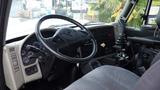 Interior cabin of a 2014 International 7500 featuring a steering wheel dashboard with gauges and a gear shifter