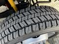 Close-up of a textured tire tread from a 2011 Ford F-450 SD showcasing deep grooves and patterns designed for traction and stability