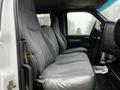 Two gray cloth front seats inside a 2005 GMC C5 Duramax with a black dashboard and steering wheel