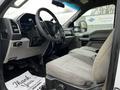 Interior view of a 2017 Ford F-550 showing the driver's seat dashboard and steering wheel with fabric upholstery and controls