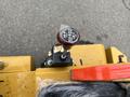 Detailed view of the control lever on a 2024 AGT Industrial KRW23 Mini Loader featuring a black and silver knob with markings for operation