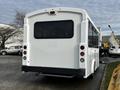 A white 2017 Chevrolet Express van seen from the rear with large windows and a simple tail light design