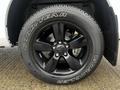 A black alloy wheel with a Goodyear Wrangler tire mounted on a 2022 RAM 1500 Classic