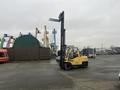 A yellow 2000 Hyster 120 forklift with a raised mast and forks is positioned on a paved surface