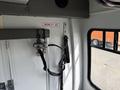 Interior view of a 2010 Ford Econoline with mobility aid straps mounted on a wall