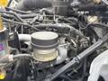A close-up view of the engine components of a 2017 Hino 338 including various hoses wires and mechanical parts