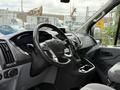 Interior view of a 2017 Ford Transit showing the steering wheel dashboard and control panel
