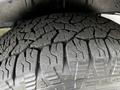 Close-up of the tread pattern on a tire mounted on a 2022 Ford Transit showing deep grooves and rugged texture designed for traction