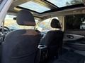 The interior of a 2021 Nissan Murano showing the front seats and view of the panoramic sunroof