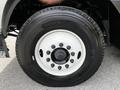 Close-up of a 2012 Autocar Xpert tire featuring a black rubber tread and white wheel rim with multiple lug nuts