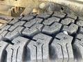 Close-up view of a rugged tire tread on a 2012 Ford F-150 showcasing deep grooves and a durable design for off-road performance