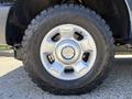 Close-up of a chrome wheel rim with a BFGoodrich all-terrain tire on a 2014 Ford F-250 SD