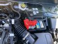 A close-up view of the engine compartment of a 2023 Ford Bronco Sport showcasing the battery and various engine components